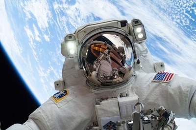 NASA astronaut takes selfie from space with Earth behind him