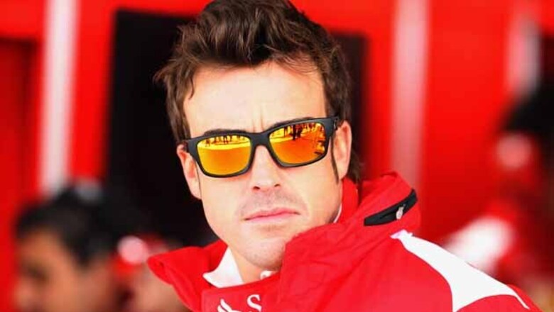 Ferrari's Alonso staggered but looks to fight on
