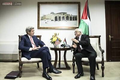 Palestinian protesters shout slogans in protest of John Kerry's visit