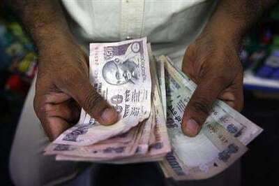 Rupee falls on choppy local shares; closes at Rs 61.53 vs dollar